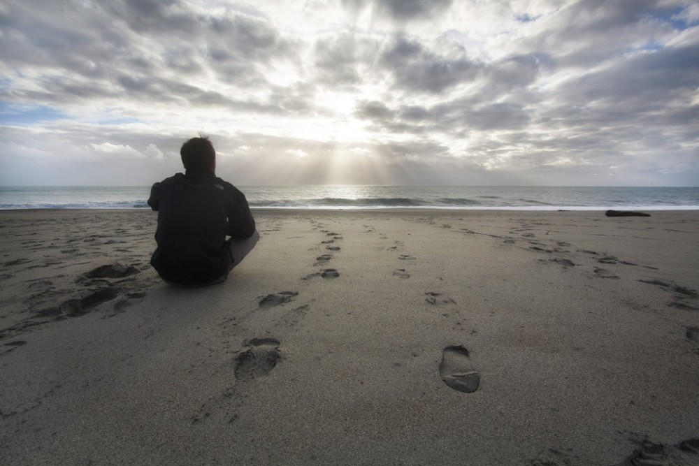 devotional beach man contemplating
